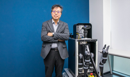 장병탁 서울대 AI연구원장이 실험 중인 AI로봇과 함께 포즈를 취하고 있다. 이슬기기자 9904sul@